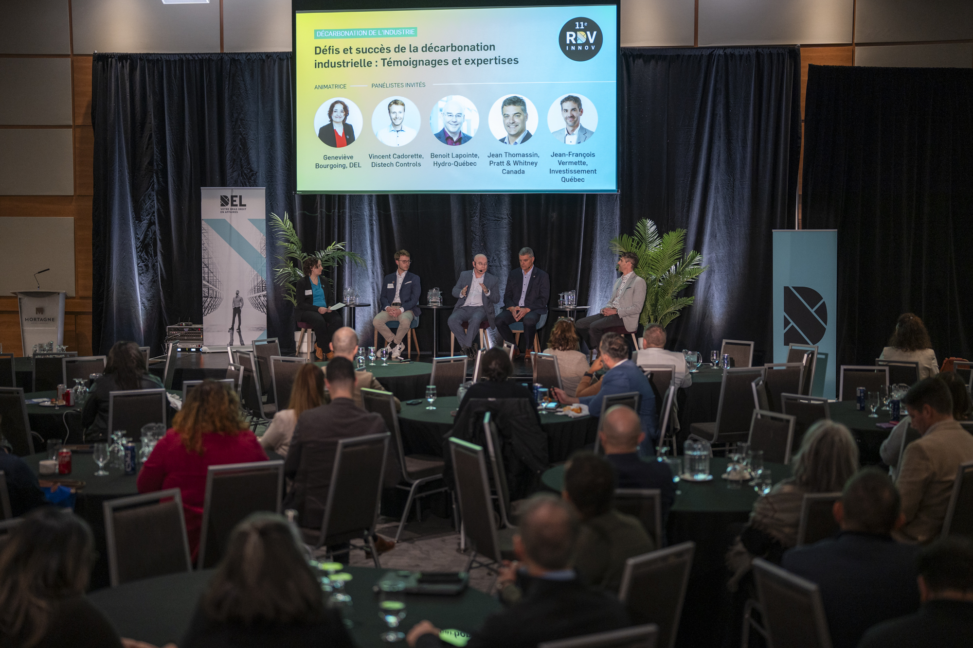 A panel discussion on stage at a conference RDV Innov event